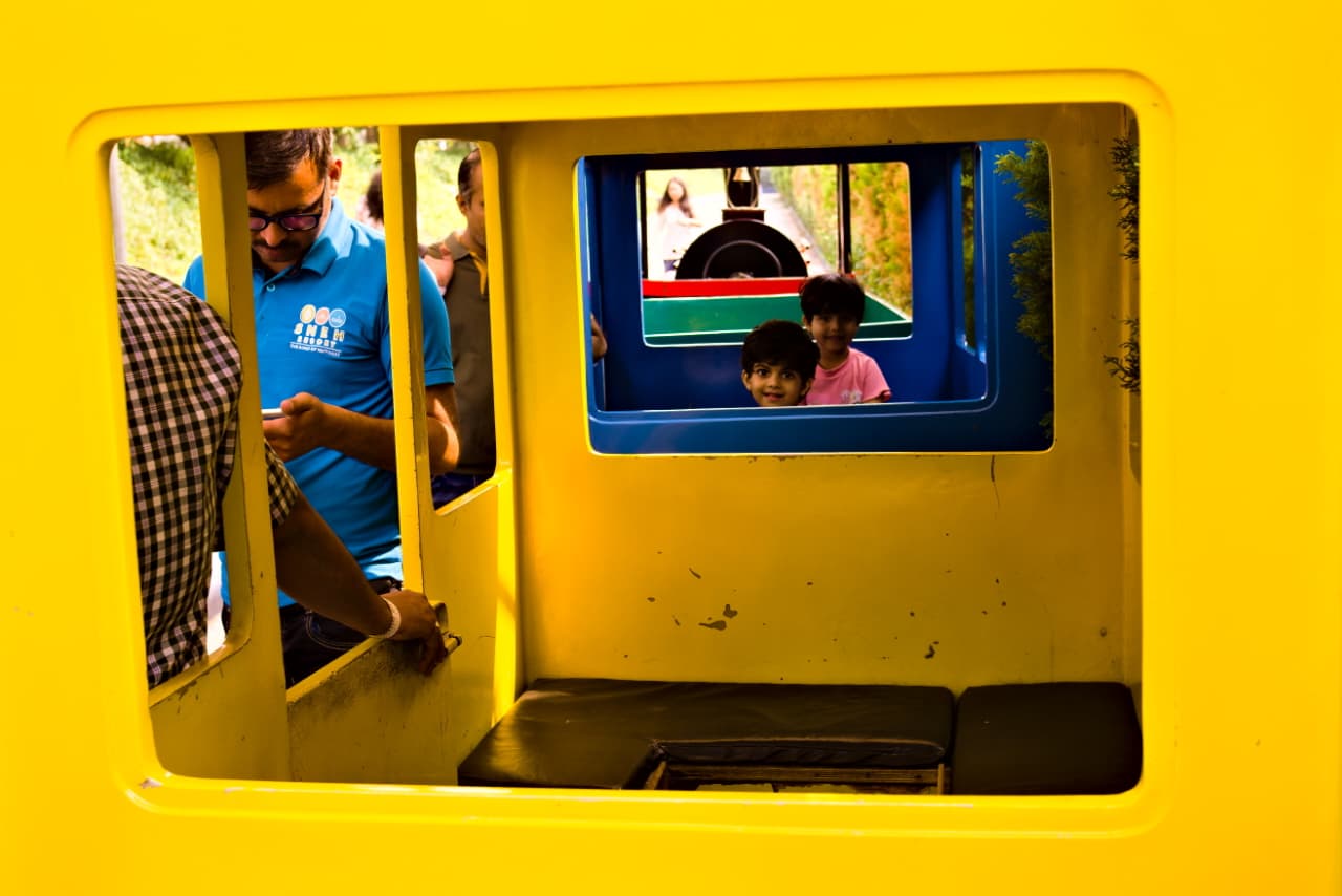 Kids in yellow toy train