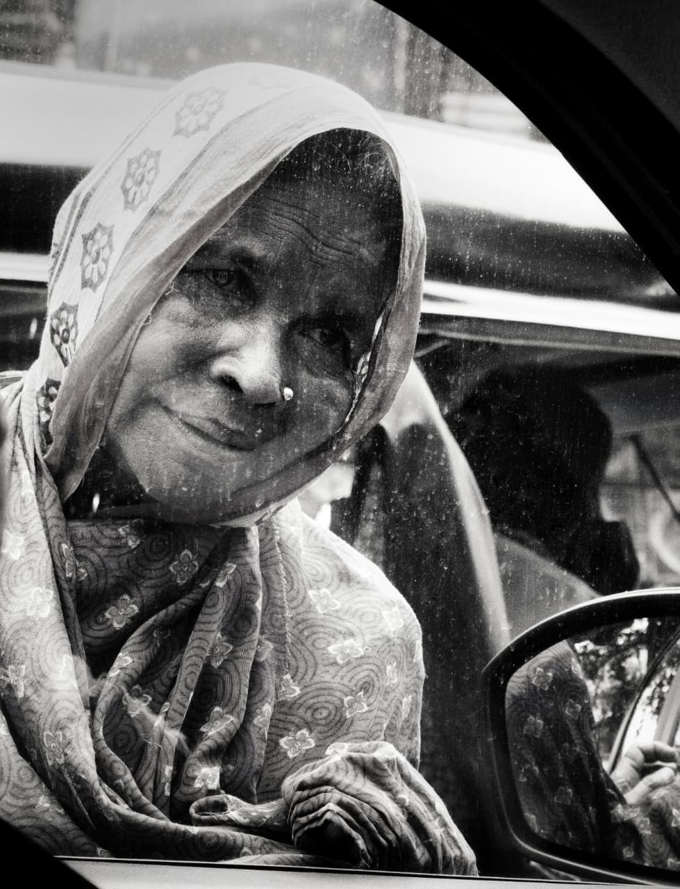 Woman looking through car window